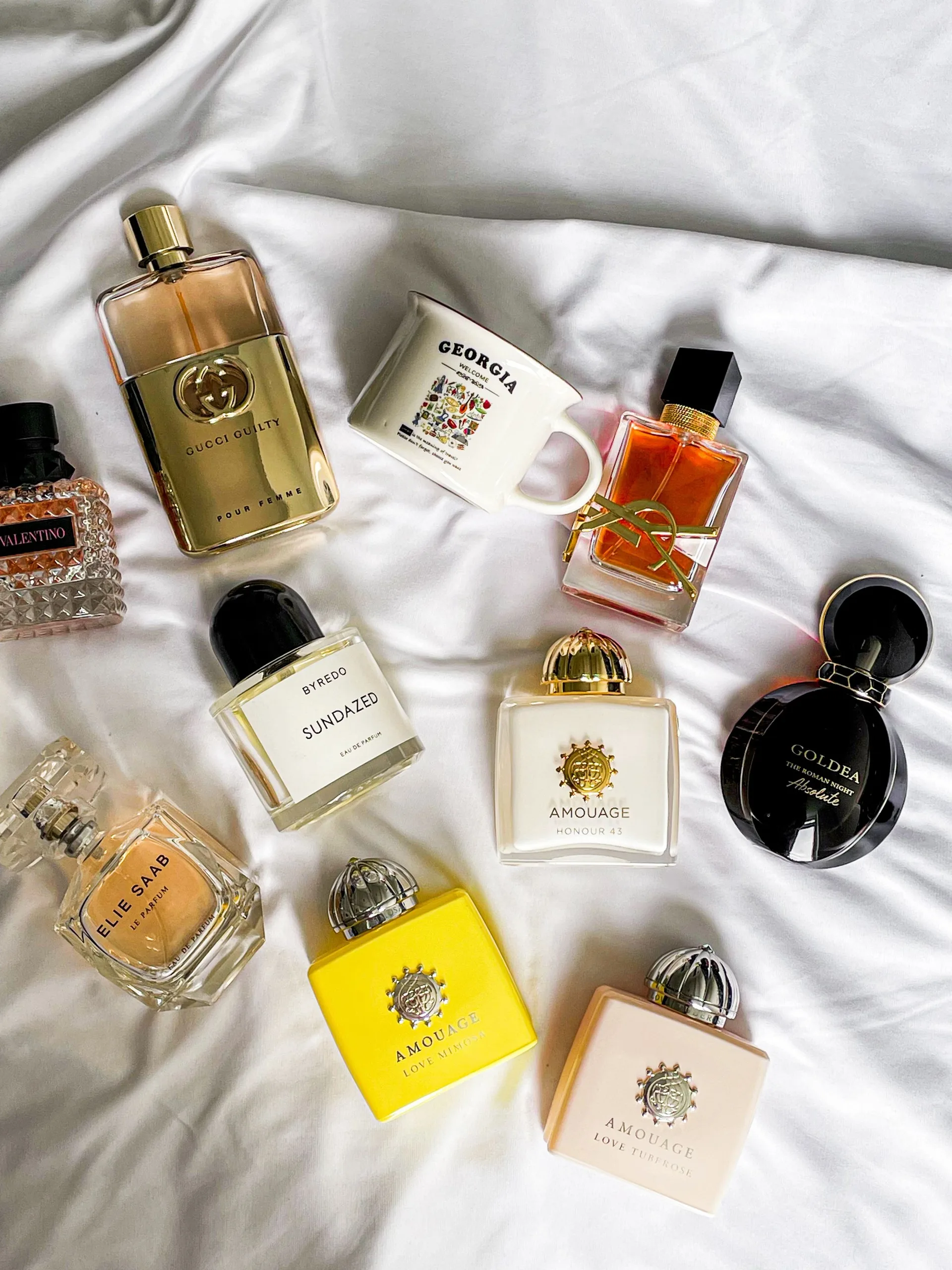 A curated flat lay of PLUME perfume bottles
