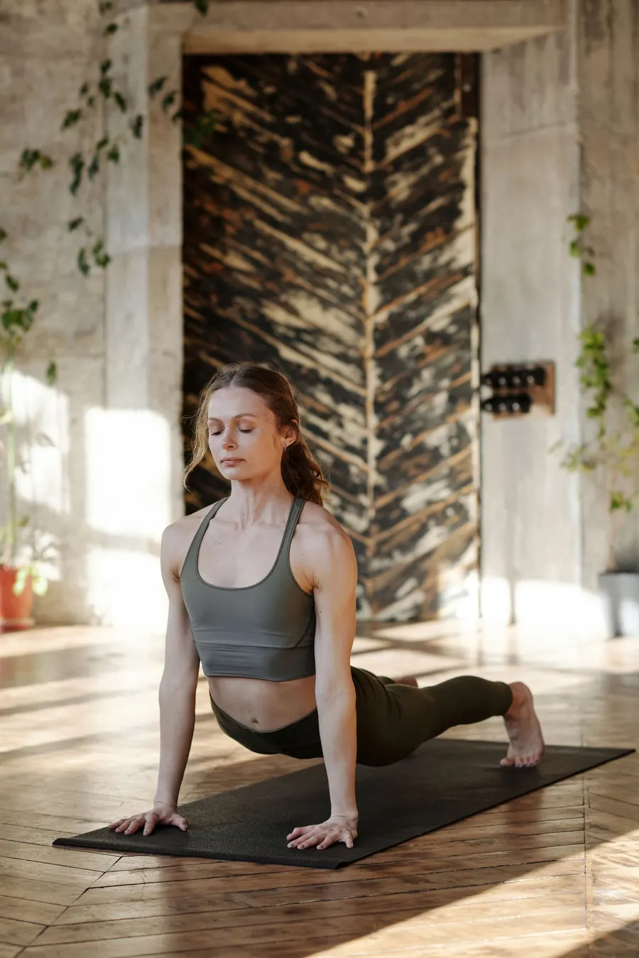 A woman stretching in a sunlit room