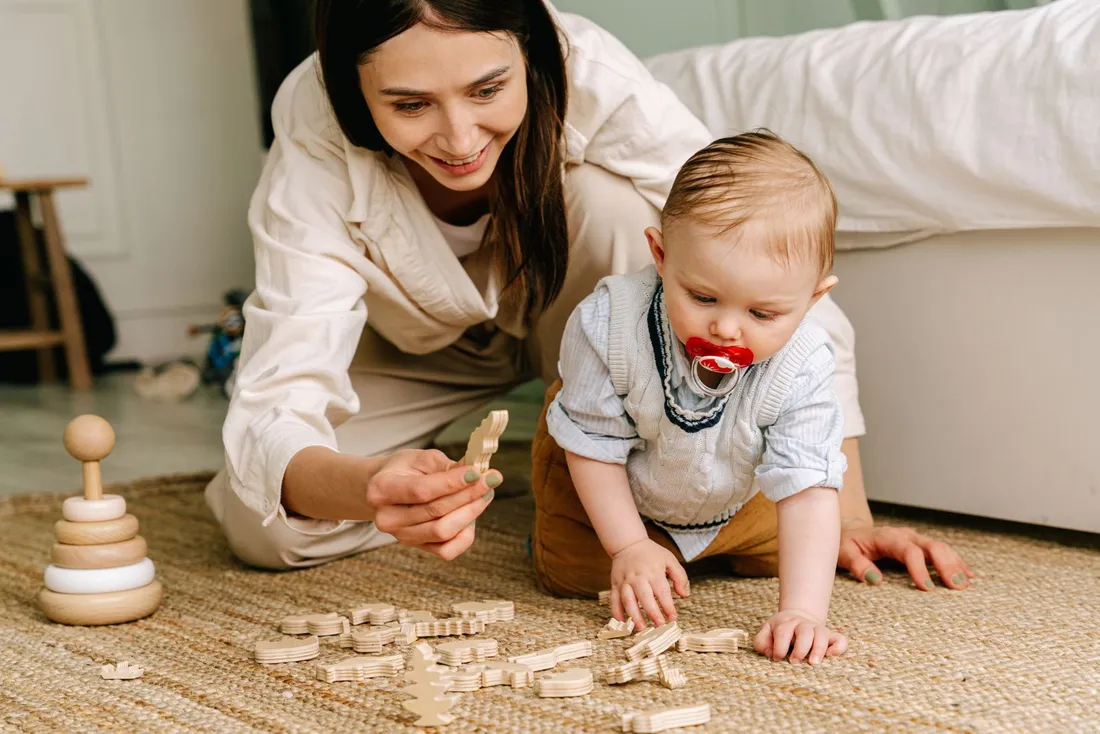 A baby playing with wooden toys