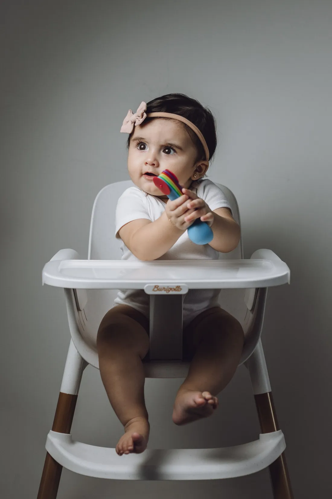 A child sitting in a high chair at feeding time