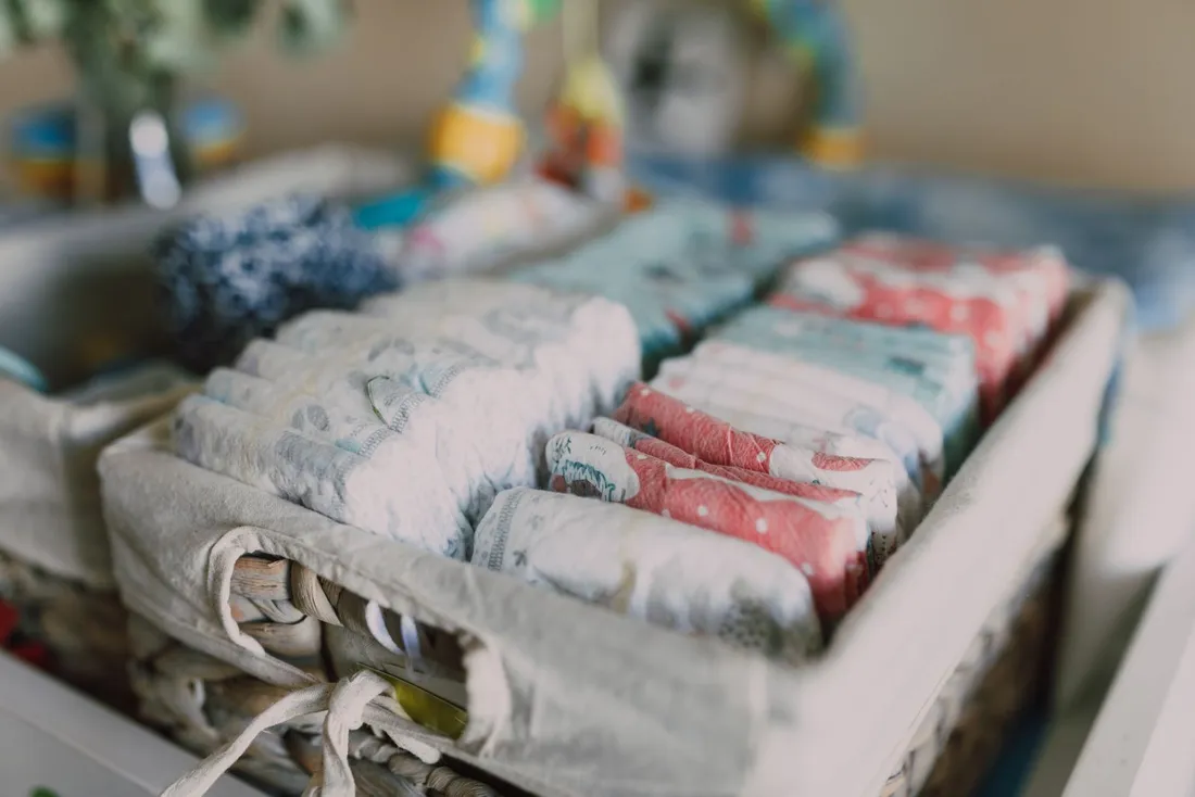 Neatly organised diapers on a woven basket