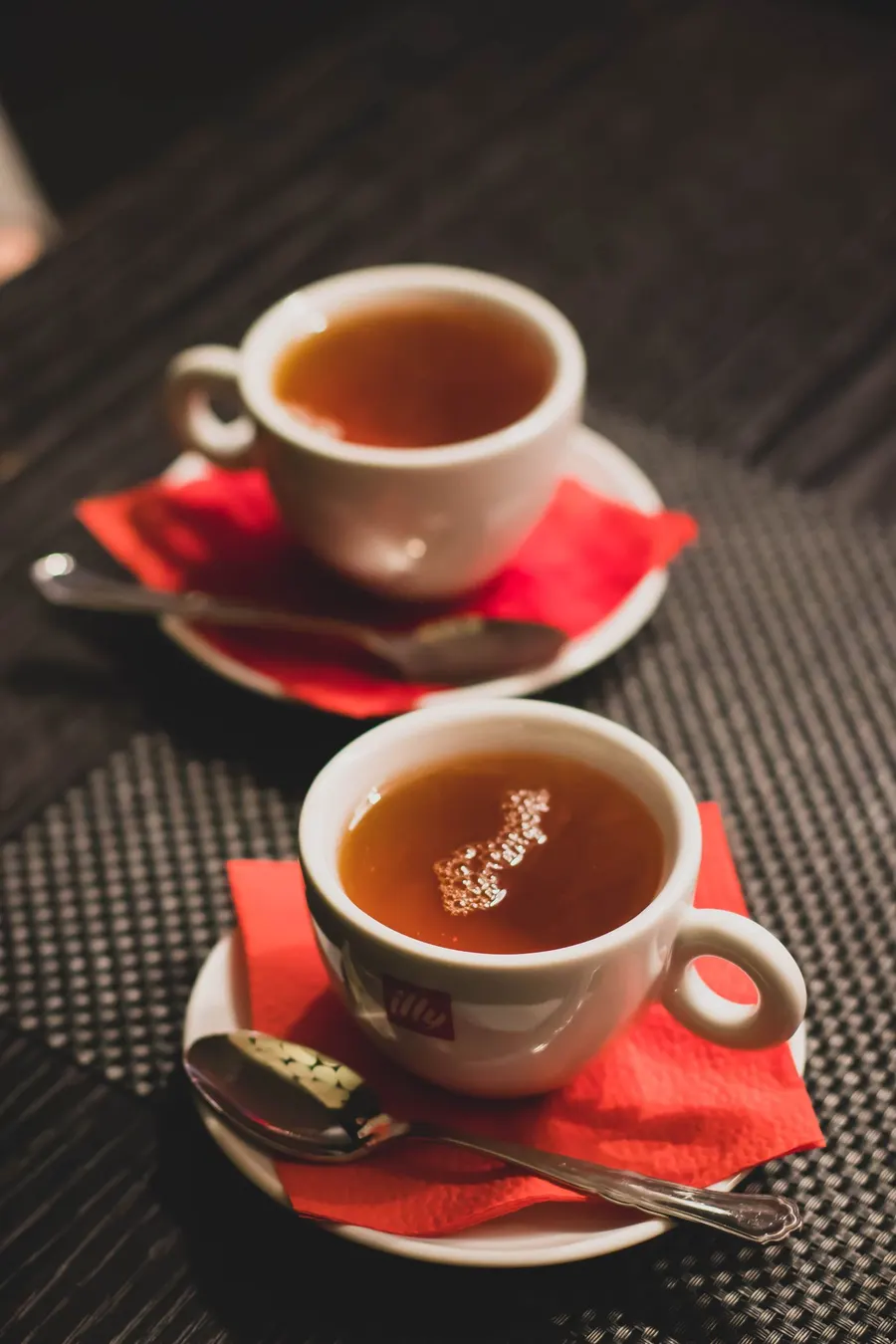A cup of tea with a saucer and teaspoon