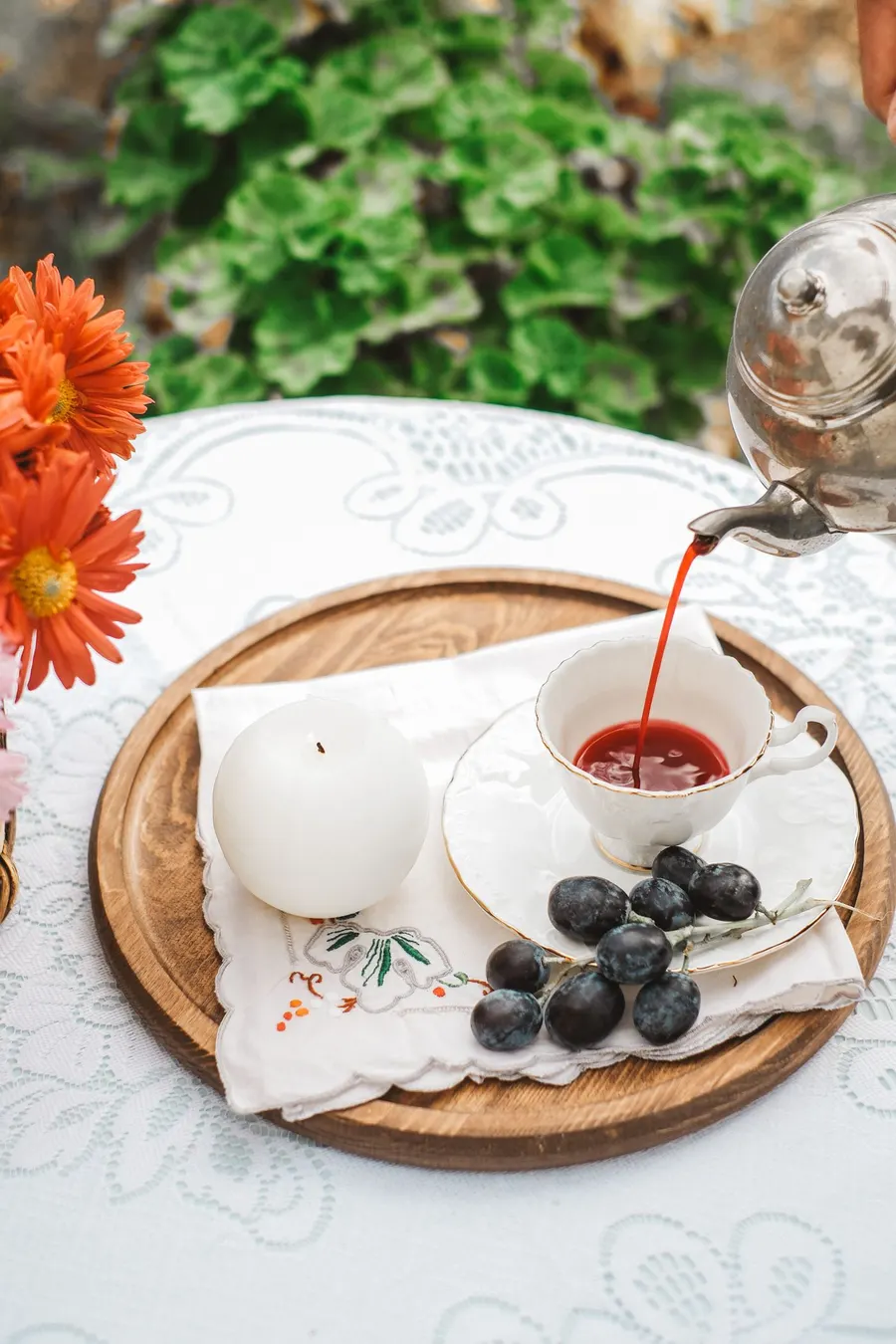 A person pouring tea into a cup