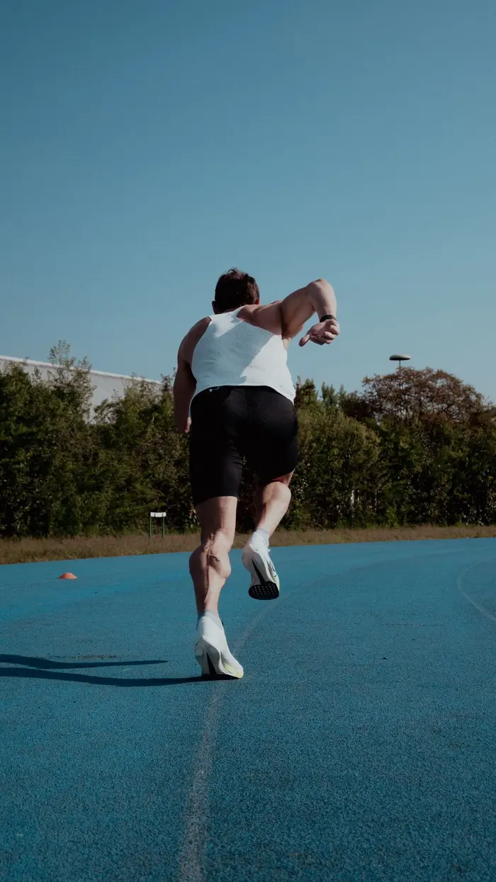 An athlete sprinting on an outdoor track
