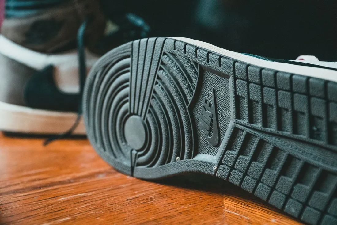 Stylish sneakers with a rubberized sole on a wooden floor