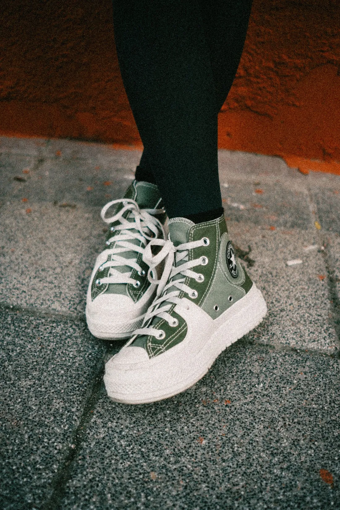 Close-up of green running shoes on pavement