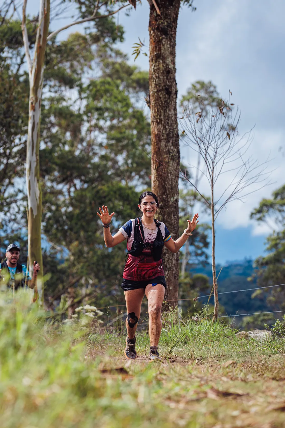 A female trail runner in a forest landscape