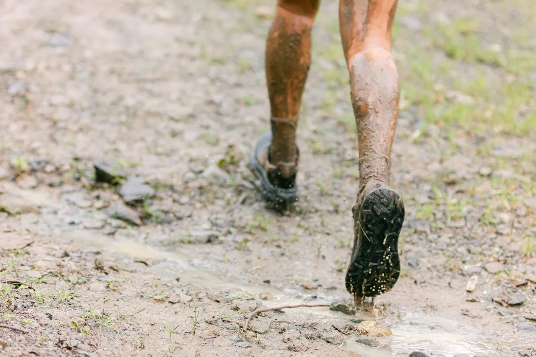 Mud-covered legs during a trail run adventure