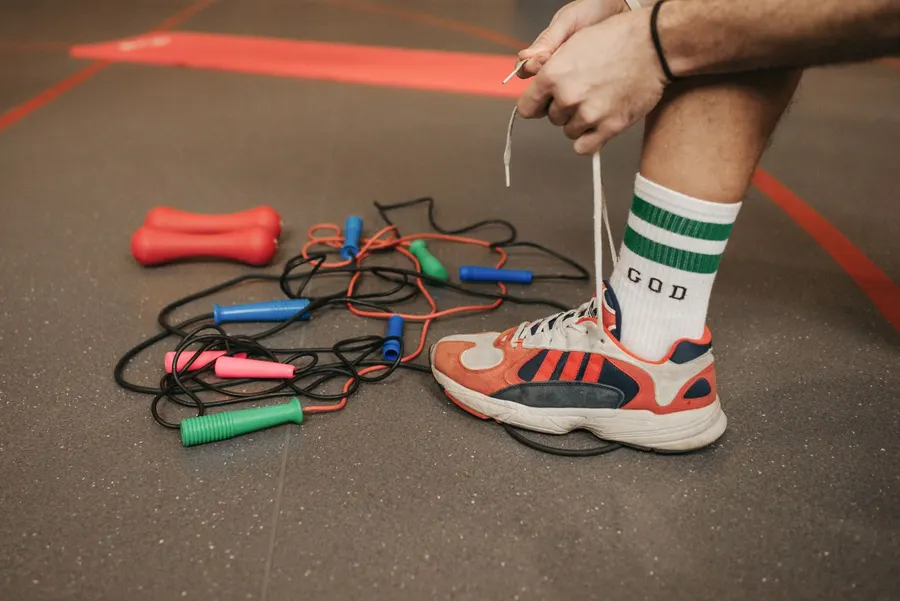 A close-up of someone lacing a training shoe