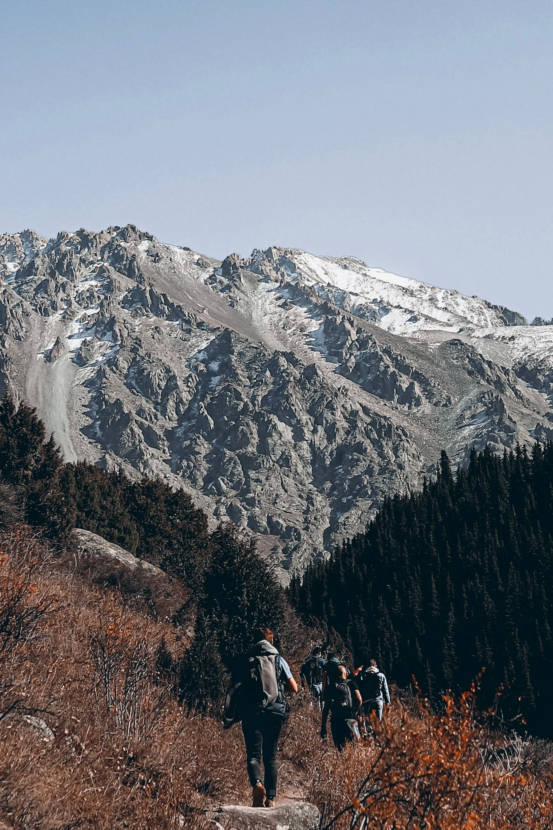 A hiker walking along a mountain ridge trail