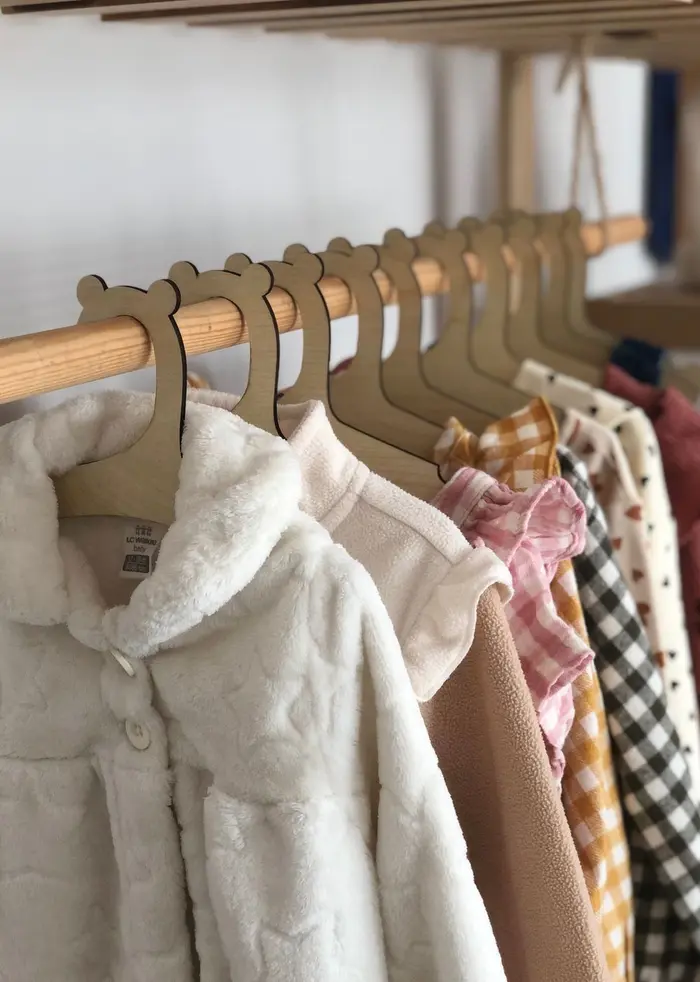 Children's clothing hanging on colorful hangers