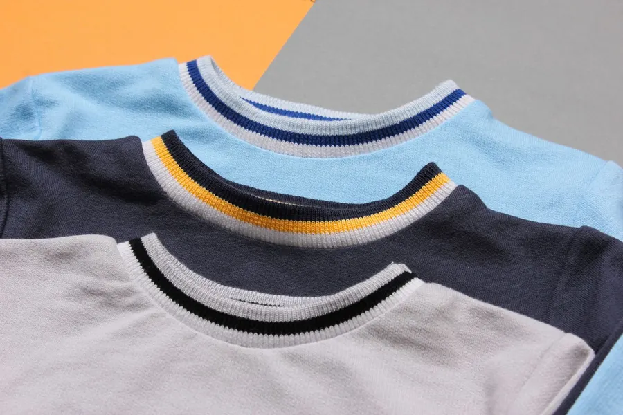 Colorful crewneck sweaters displayed flat