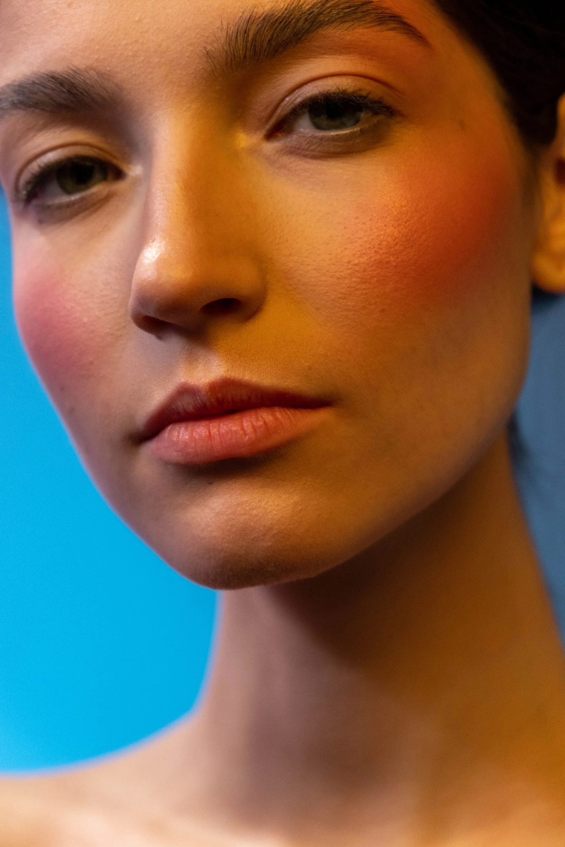 Close-up portrait of a woman with natural makeup and subtle blush