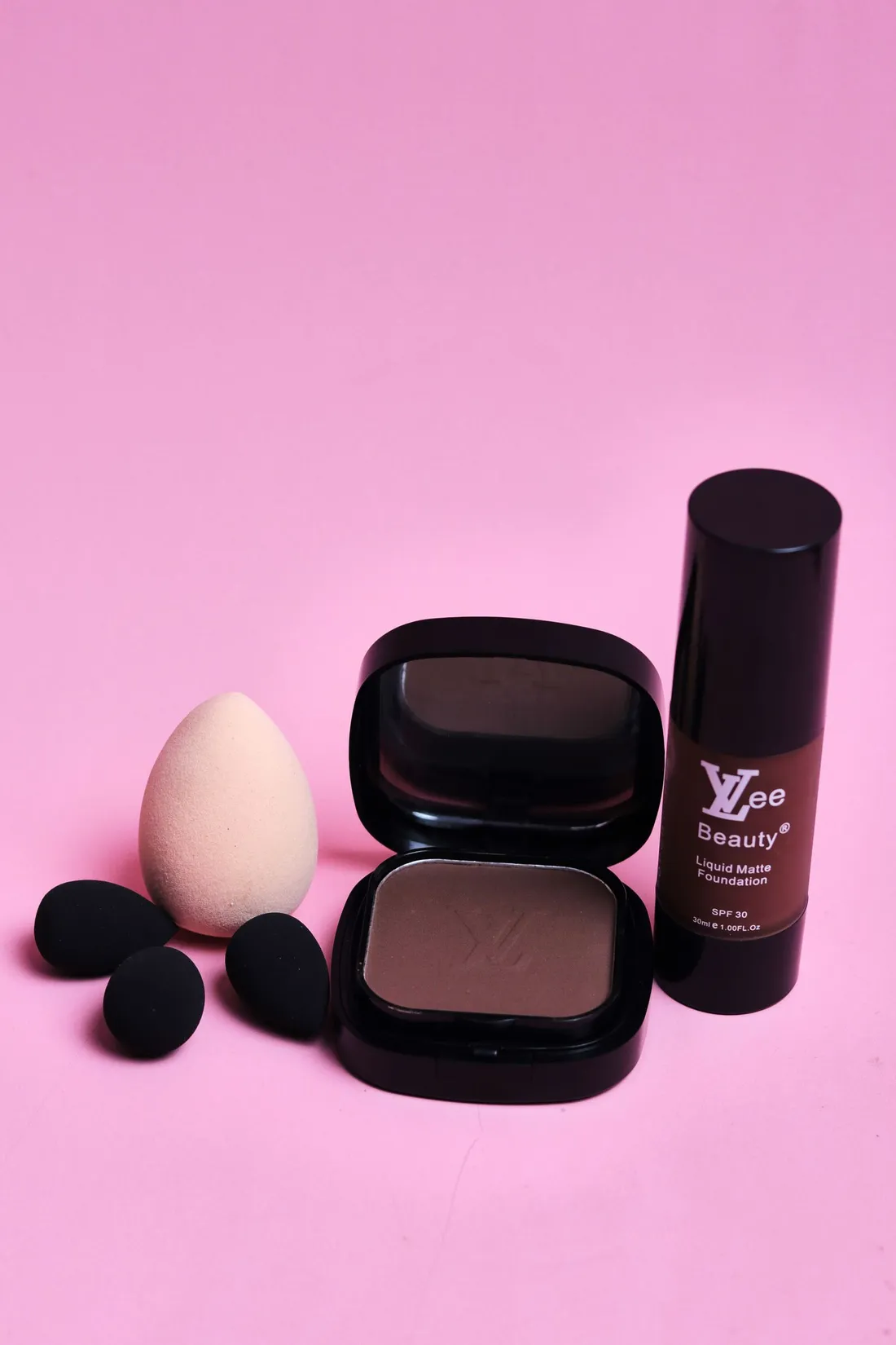 Foundation, concealer and sponge arranged for a clean beauty setup