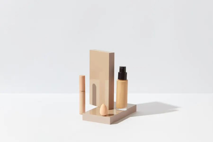 Foundation, concealer and sponge arranged for a clean beauty setup
