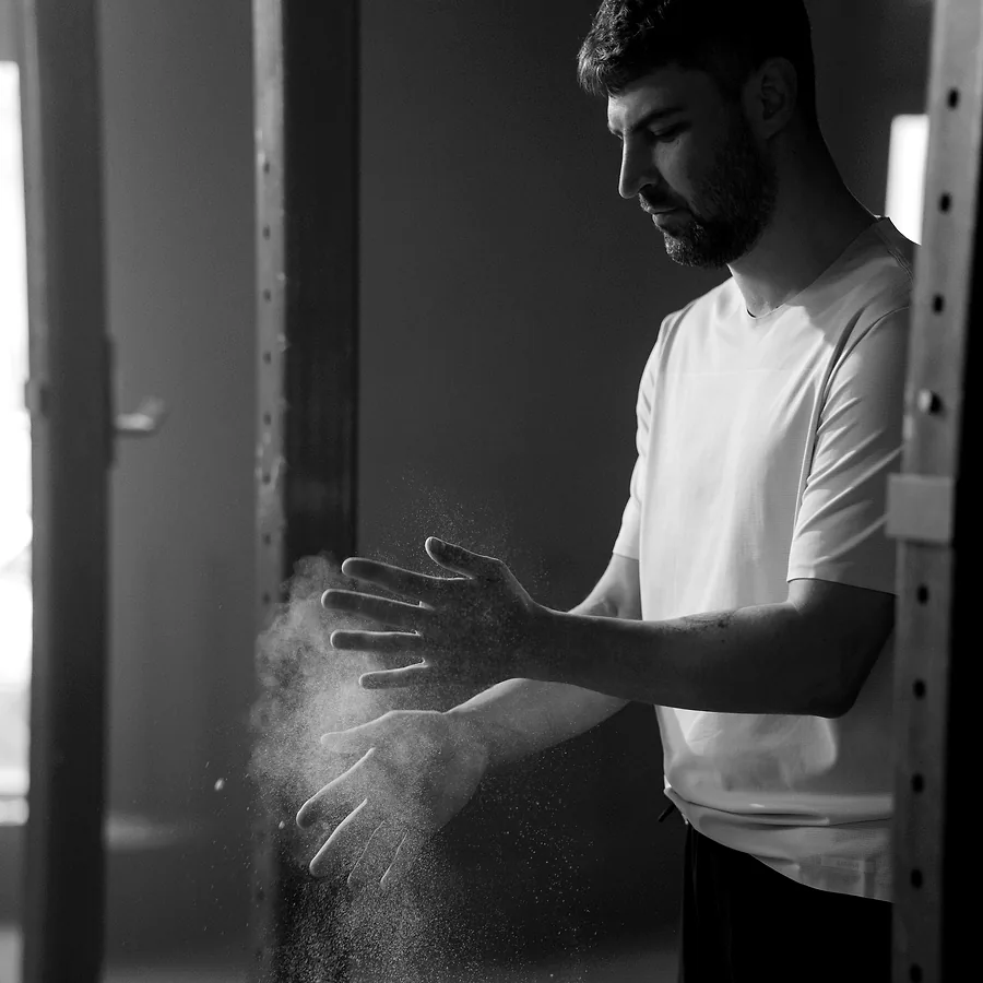 Chalk clapped off a pair of hands, the dust caught in the light