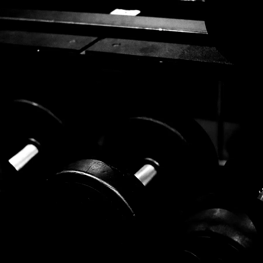 Close on the dumbbell rack, knurling and chipped paint
