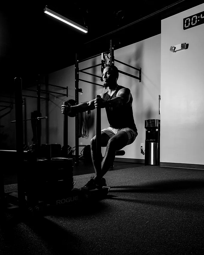 A member holding the bottom of a loaded split squat