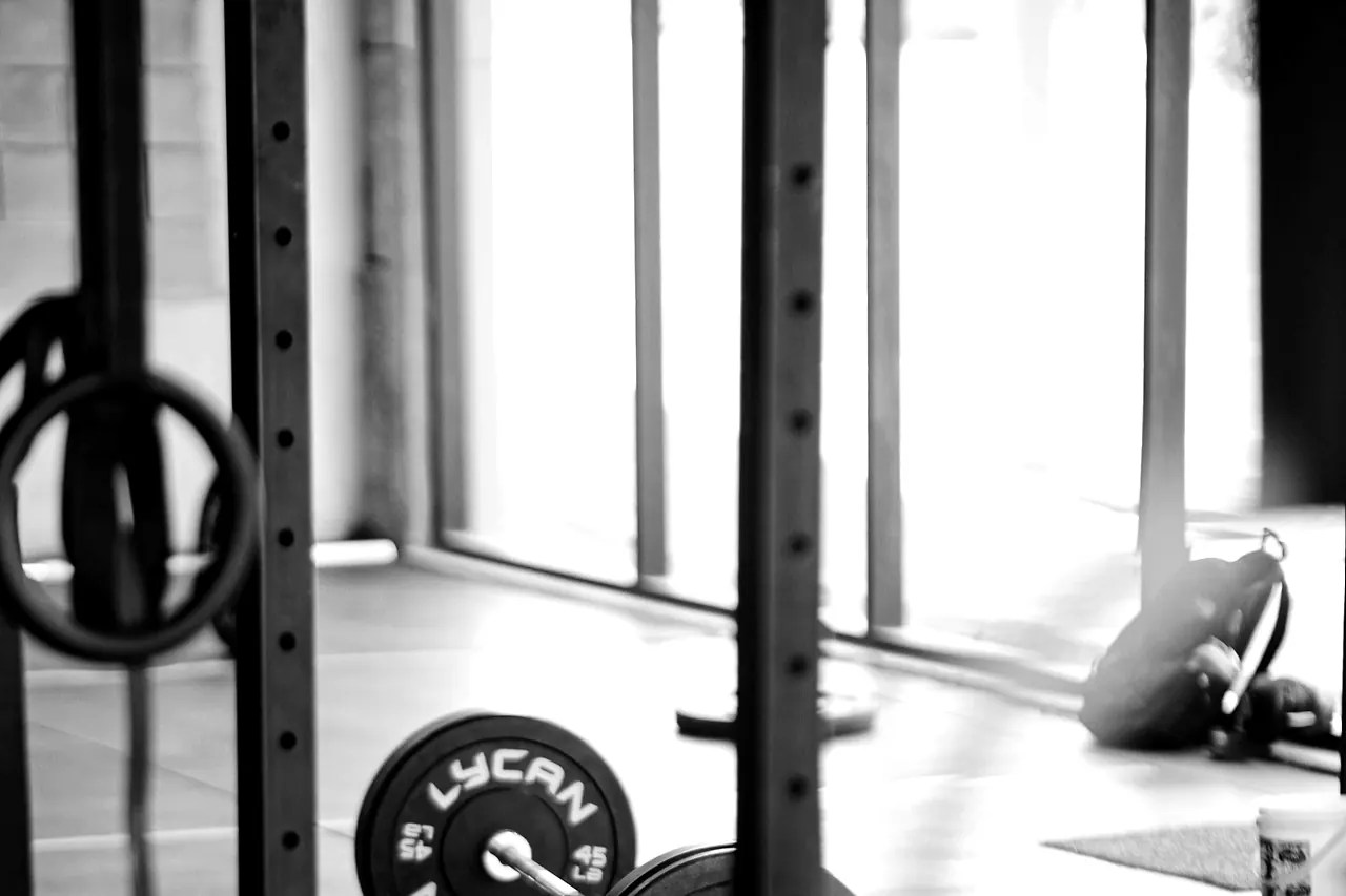 The lifting floor after hours, racks and a loaded bar left standing