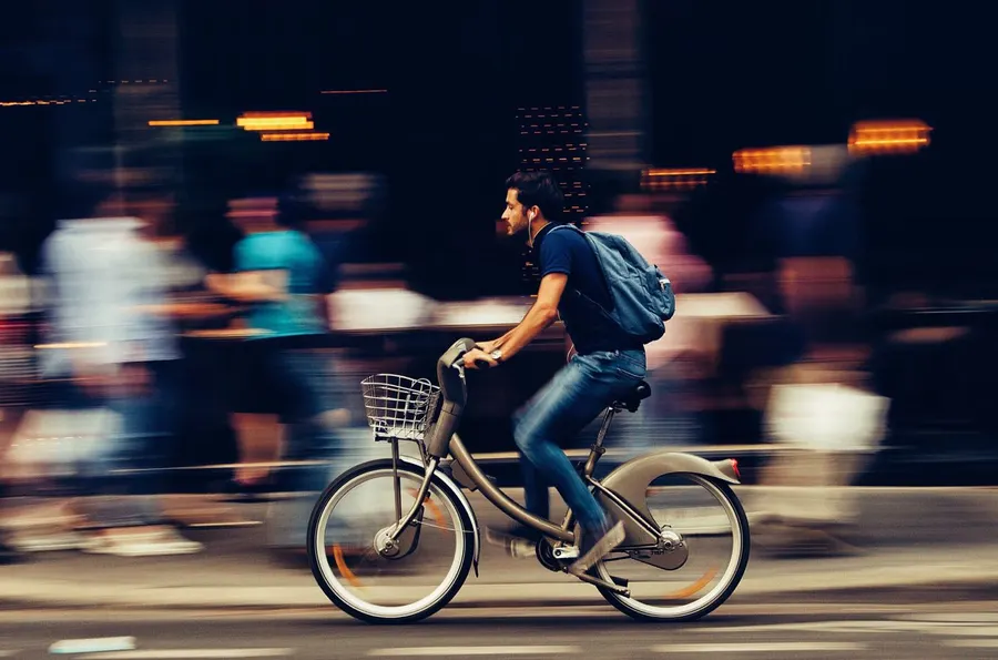 A cyclist riding a bicycle on a city street