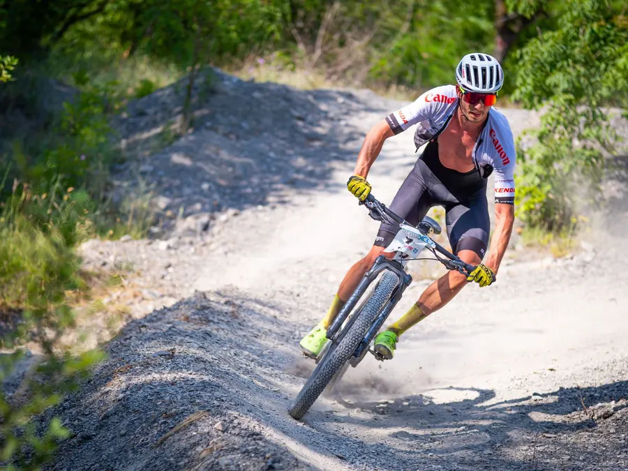 A cyclist riding a mountain bike on a country road
