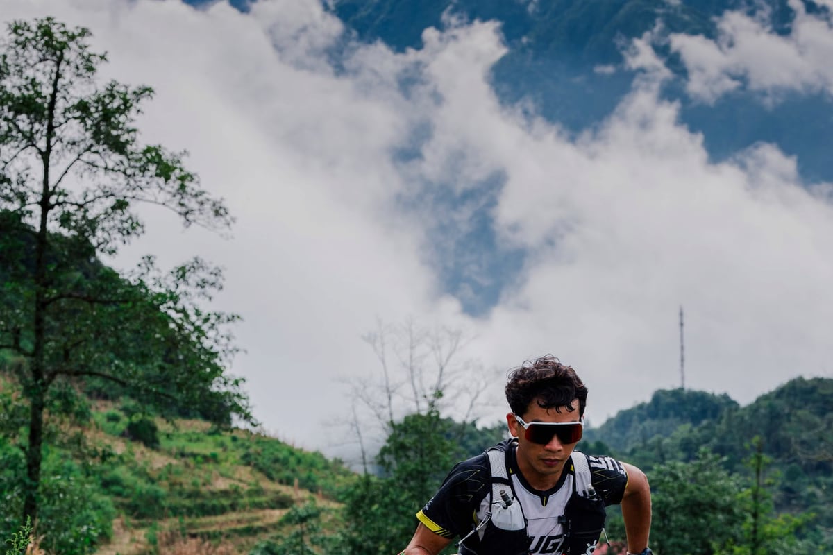 Trail rider navigating a scenic mountain path through summer alpine terrain