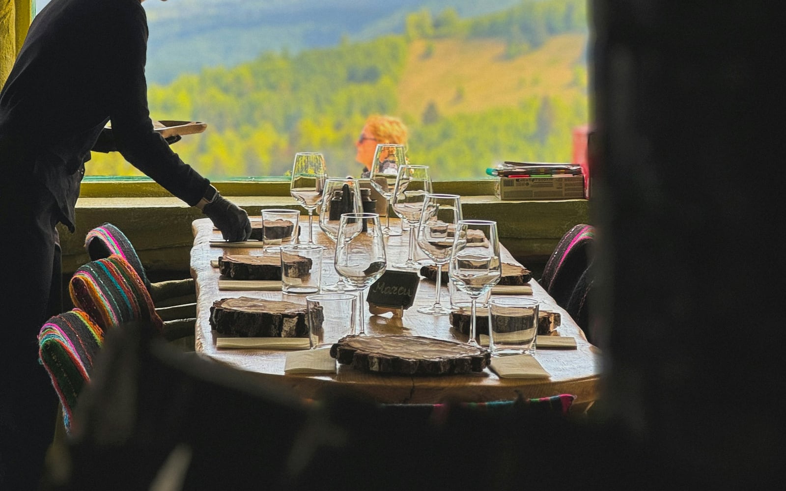 The Panorama Restaurant at dusk: warm light, set tables and the range outside the glass