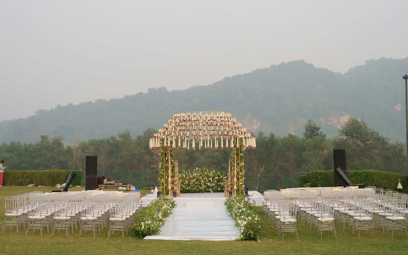 The Summit Terrace set with rows of white chairs facing the range at golden hour