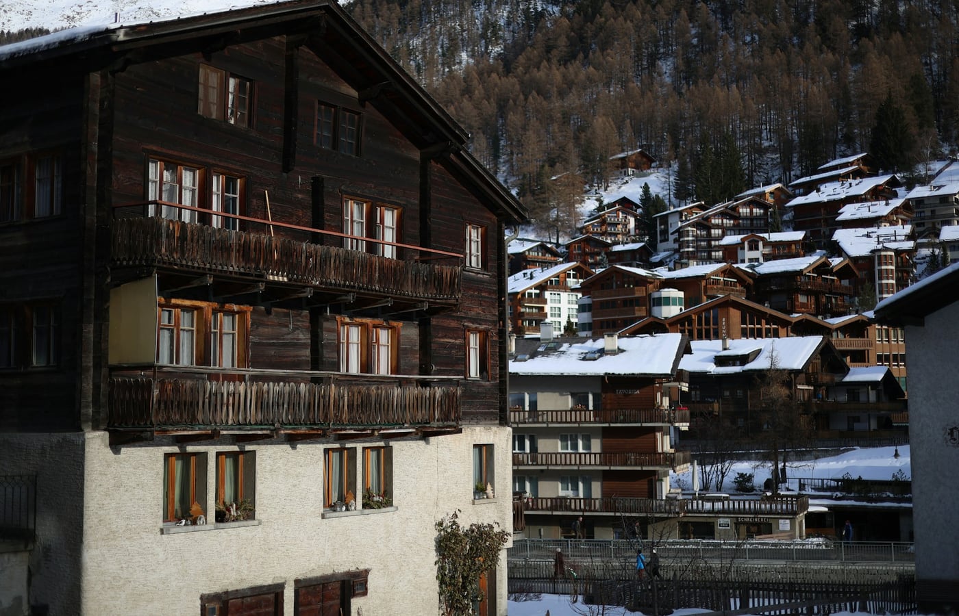 Winter at Vespera with deep powder snow, frost-covered chalets, and distant peaks