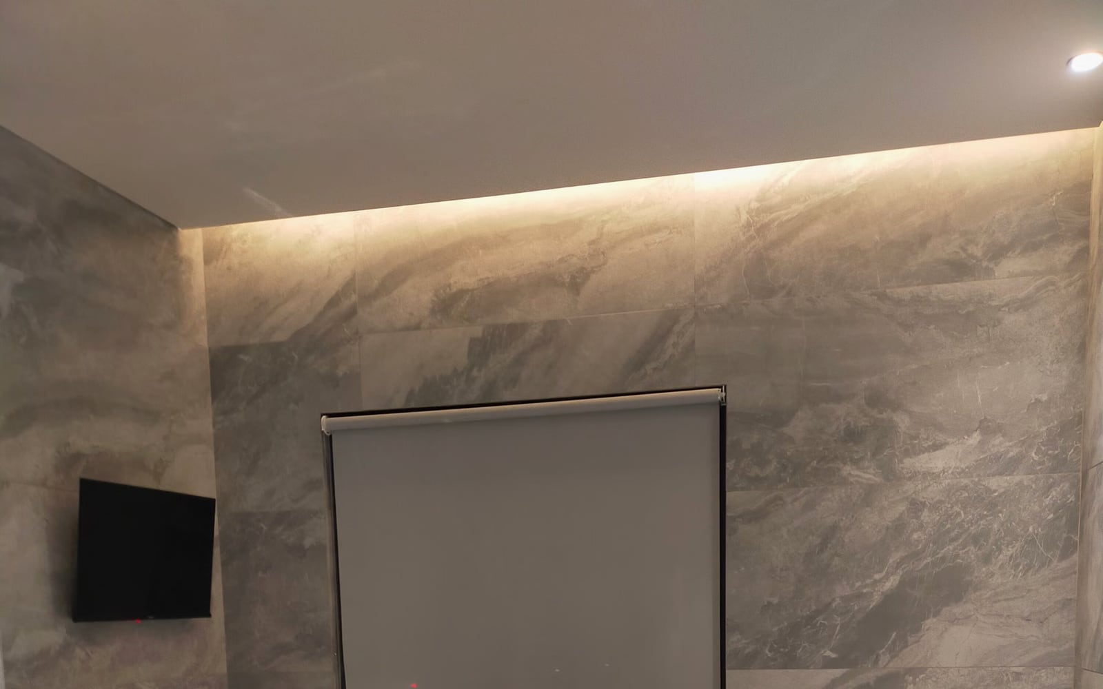 A treatment room in soft light with folded linens and alpine botanicals