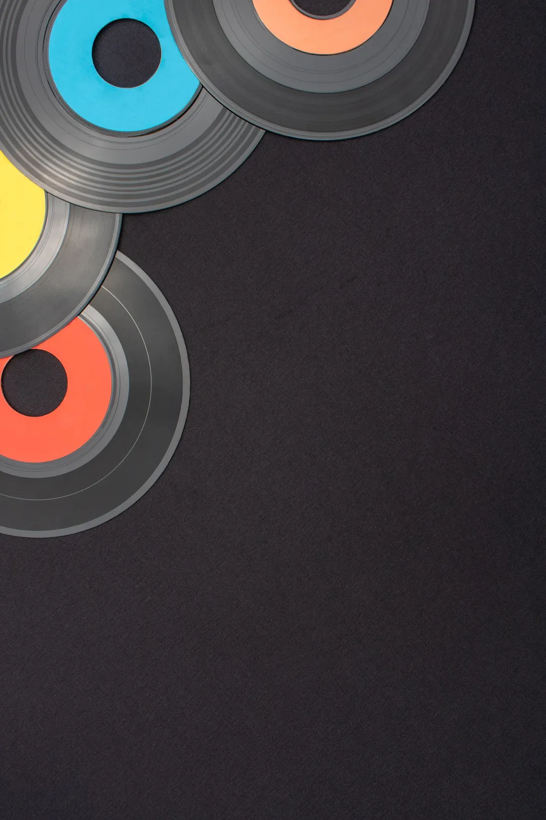 Multi-coloured 7-inch vinyl records laid out flat