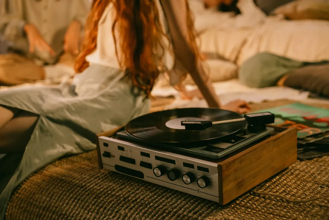 A vintage record player on a textured rug