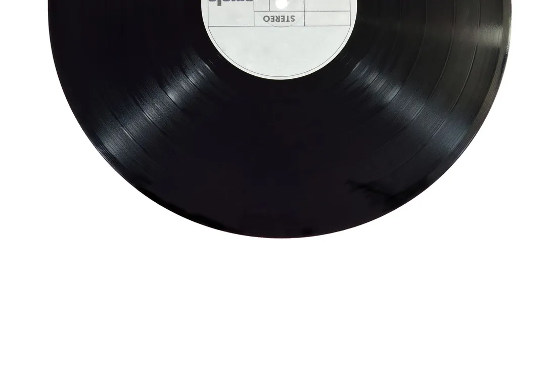 Close-up of a black vinyl record with a blank white label