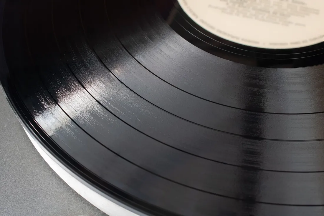 Close-up detail of a vinyl record showing its texture and grooves